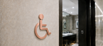 DUROSIGN WASHROOM SIGN FOR DISABLE - STAINLESS STEEL ROSE GOLD BRUSH FINISH CUTOUT WITH  ACRYLIC BACKING